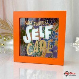 Pomarańczowa skarbonka z napisem "Mój fundusz SELF CARE" – duża skarbonka na banknoty i monety, idealny prezent na urodziny dla dorosłych i przyjaciółki.