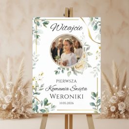 Plakat powitalny na komunię z PVC ze zdjęciem dziecka i zielonymi gałązkami eukaliptusa wokół zdjęcia.